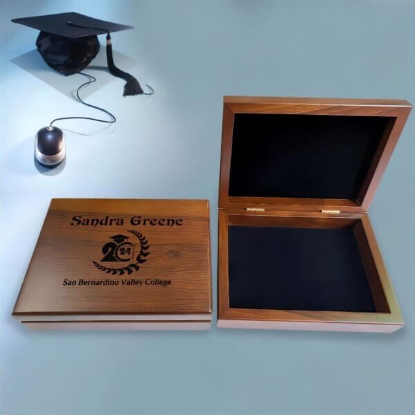 A wooden graduation keepsake box with a cap and diploma design, perfect for storing memories.